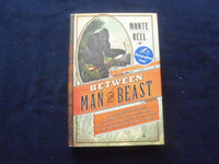 2013 BETWEEN MAN AND BEAST HARDCOVER BOOK - AUTOGRAPHED BY MONTE REEL - KD 8526